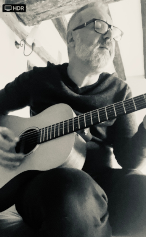 Lee playing acoustic guitar